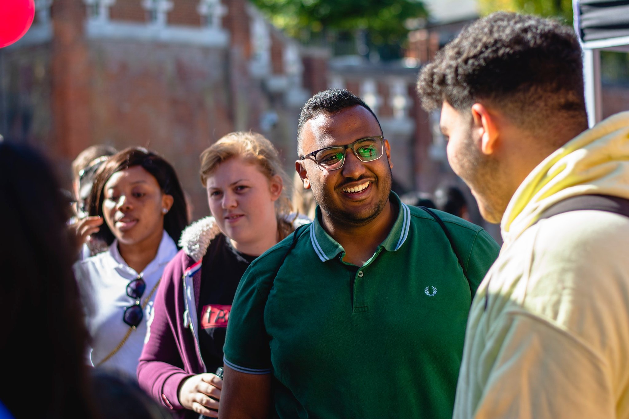 Students outside The Hub, talking to each other